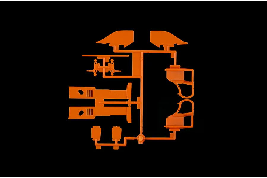 An orange plastic model kit sprue containing various car body parts for an Italeri 1/24 Porsche 956 model.