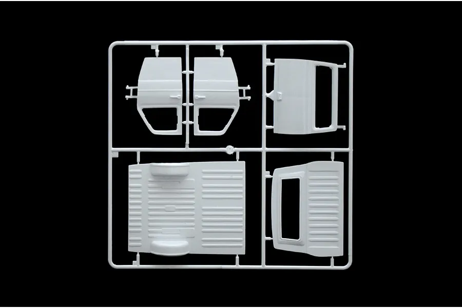 A white plastic sprue containing various vehicle body parts for a 1/24 scale model kit, including doors and floor panels, against a black background.