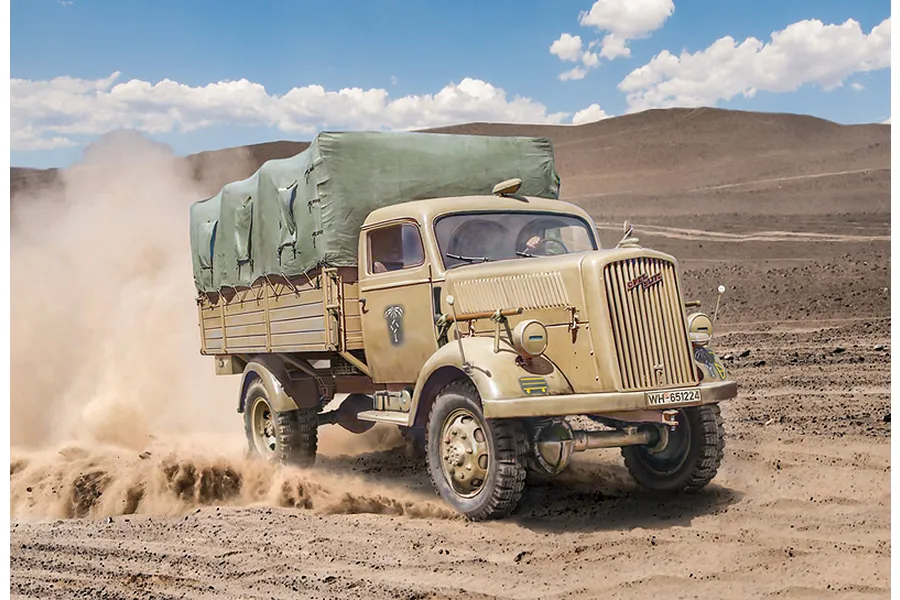 A detailed scale model of an Opel Blitz military truck driving through a desert landscape, kicking up dust.