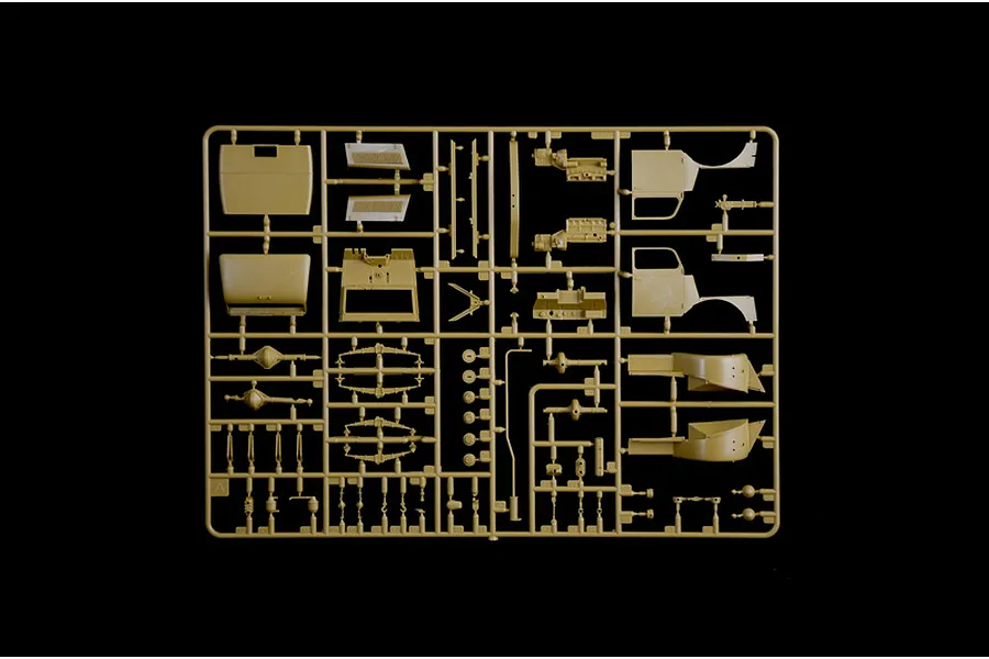 A tan plastic sprue containing various parts for a 1/35 scale model truck kit, including cab panels, suspension components, and engine parts.