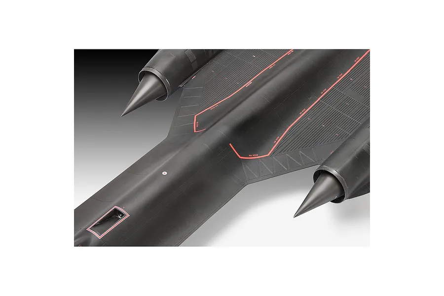 A close-up top-down view of a black SR-71 Blackbird plastic model aircraft showing engine nacelles and red warning markings on the fuselage.