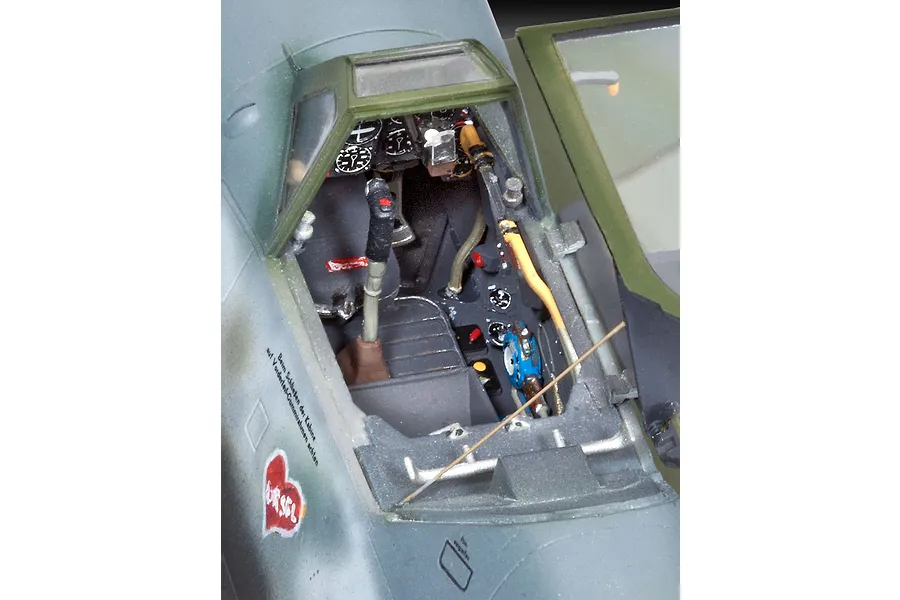 Close-up of the detailed cockpit interior of a 1/32 scale Messerschmitt Bf109G-10 model aircraft, showing the seat, control stick, and instrument panel.