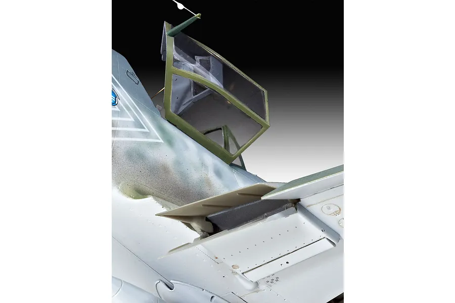 Close-up of the cockpit and wing root area of a 1/32 scale Messerschmitt Bf109G-10 model aircraft, showing the open canopy and camouflage paint scheme.