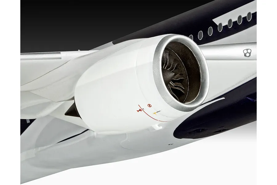 Close-up of a plastic model aircraft engine mounted on a wing, featuring white casing and dark fan blades.