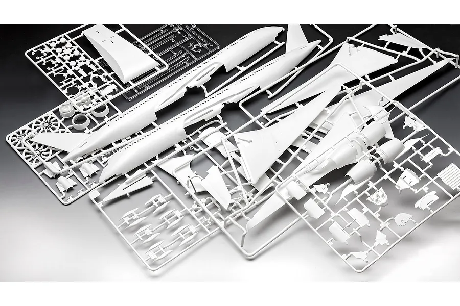 White plastic model aircraft kit sprues for a Revell A350-900 model, including fuselage halves, wings, and engine parts on a dark background.