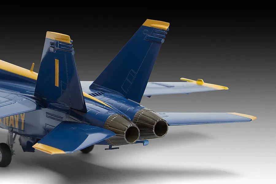 Rear view of a 1/72 scale plastic model of a Blue Angels F/A-18 Hornet jet, showing the twin engine exhausts, vertical stabilizers, and blue and yellow livery.