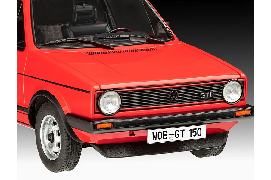 A close-up front view of a red 1/24 scale model Volkswagen Golf GTi, showing the grille, headlights, and license plate.