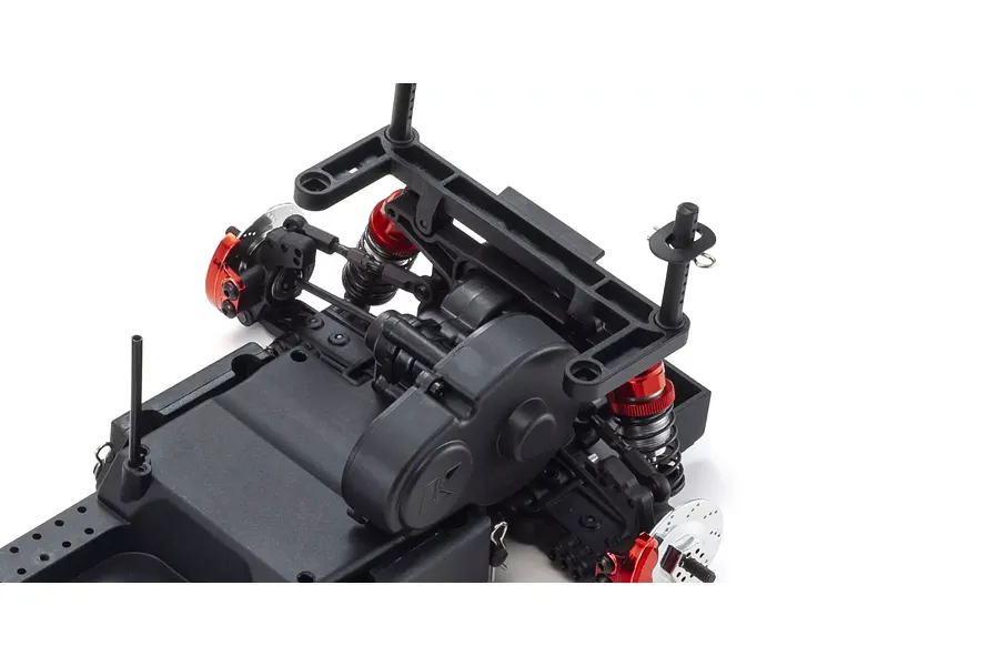 Close-up of the rear chassis assembly of a Kyosho Fazer D2 RC drift car, showing the motor mount, suspension, and red anodized shock components.