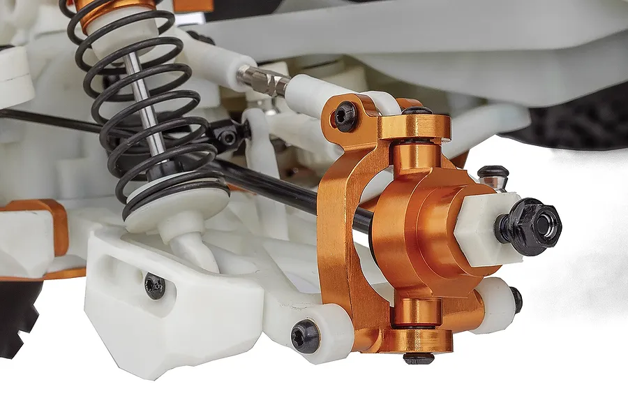 Close-up of the front suspension and steering knuckle assembly on a Team Associated RC monster truck.