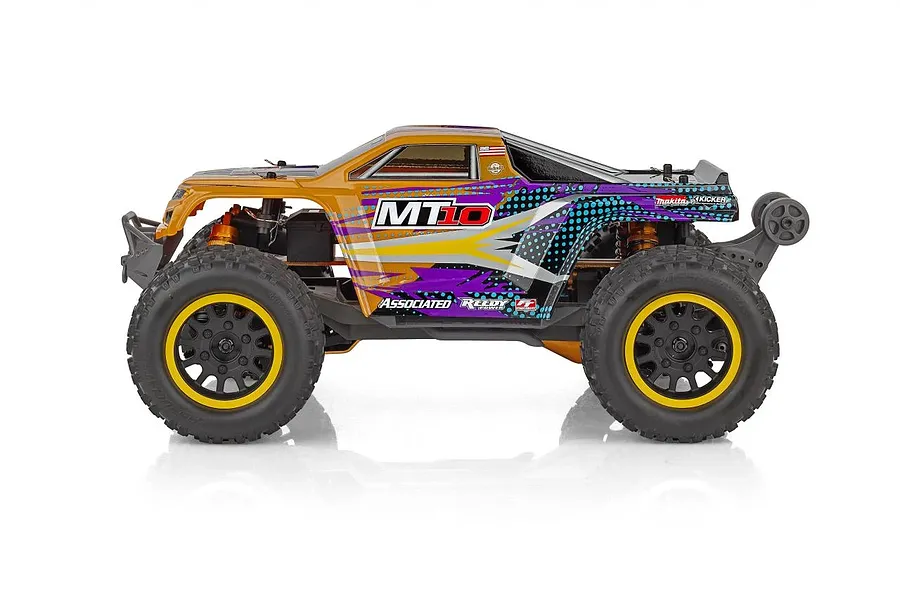 Side profile of the Team Associated Rival MT10 Factory Team RC monster truck with orange and purple bodywork on a white background.