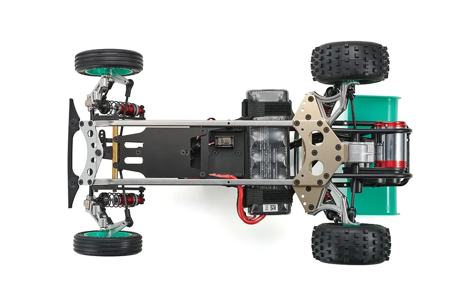 Top-down view of the Kyosho Tomahawk '85 WC Worlds Spec RC buggy chassis, showing the metal frame, battery, and suspension components.