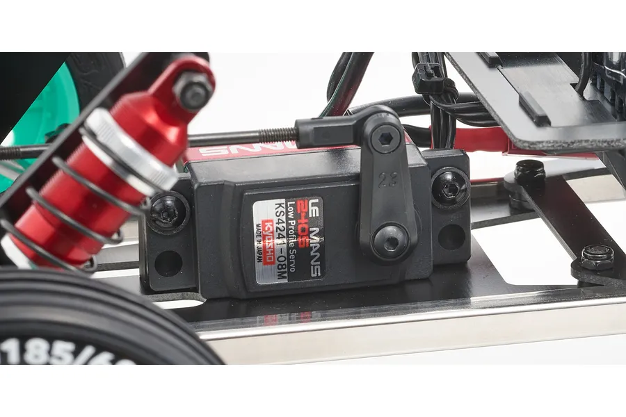 Close-up of a Kyosho Le Mans 240S low profile servo mounted on the chassis of an RC buggy.