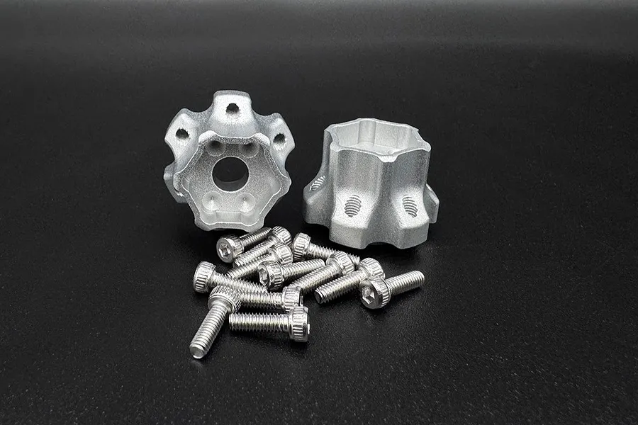 Two silver aluminium wheel hex hubs with a 10mm offset and a set of small steel socket head screws on a black background.