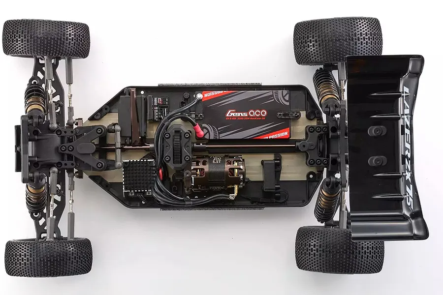 Top-down view of a Kyosho Lazer ZX7.5 1/10 scale 4WD RC buggy chassis, fully assembled with electronics, motor, and battery installed.