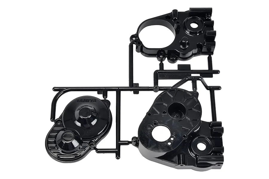 A black plastic Tamiya gearbox A parts sprue showing various housing components for an RC car.
