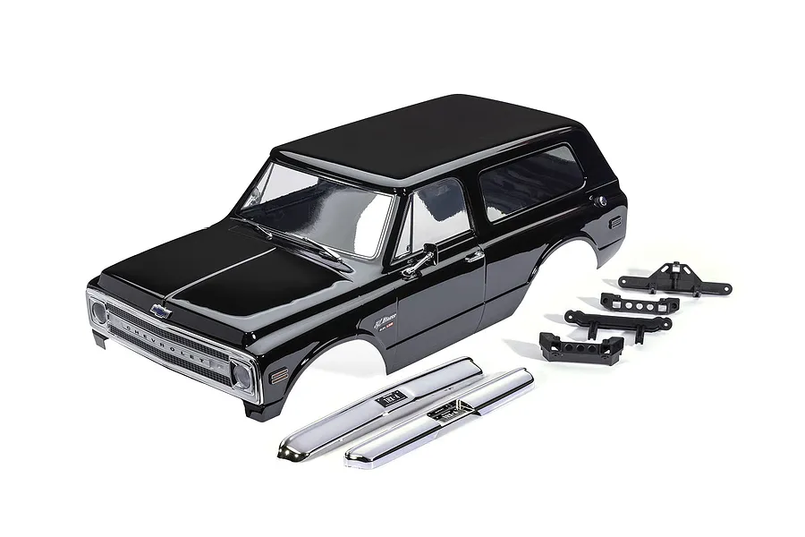 A black Traxxas 1/10 scale Chevrolet Blazer RC body shell with chrome bumpers and black plastic mounting accessories on a white background.