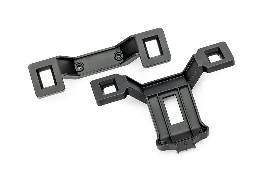 Two black plastic clipless body mounts for a Traxxas RC car, shown from an overhead angle on a white background.