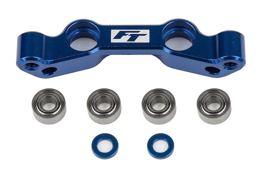 Factory Team blue anodised aluminium Ackerman plate with four metal ball bearings and two small blue spacers on a white background.