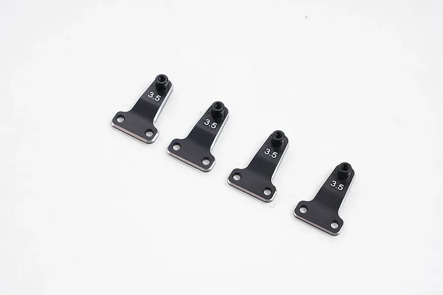 Four black metal FMS 3.5mm shock offset adjustor brackets arranged in a row on a white background.