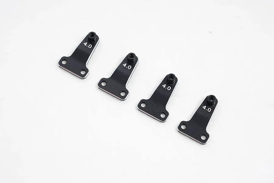 Four black metal FMS 4.0mm shock offset adjustor brackets arranged in a row on a white background.