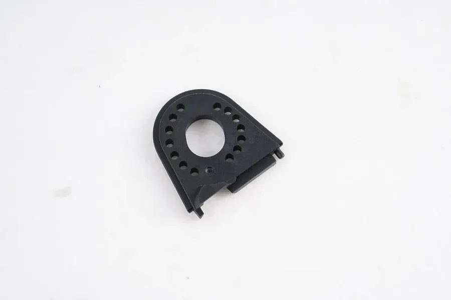 A black plastic FMS motor mount with a circular center hole and multiple mounting holes, isolated on a white background.