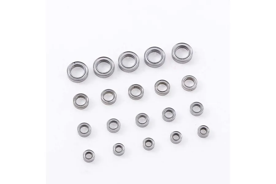 A collection of various sized metal ball bearings arranged on a plain white background.