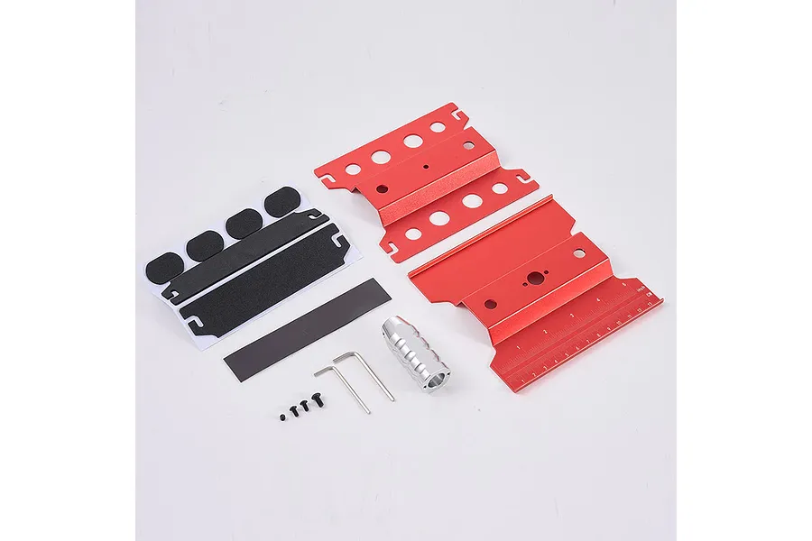 Disassembled red aluminium RC maintenance stand kit with foam pads, screws, hex keys, and a silver handle on a white background.
