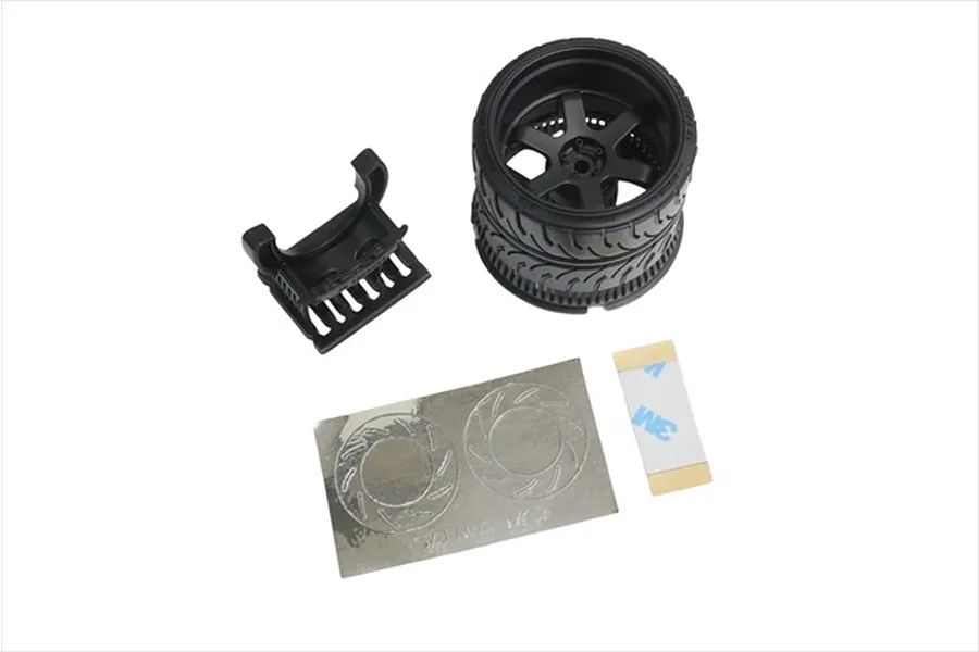 A black 6-spoke RC transmitter steering wheel accessory kit including a wheel, mounting bracket, and adhesive decals on a white background.