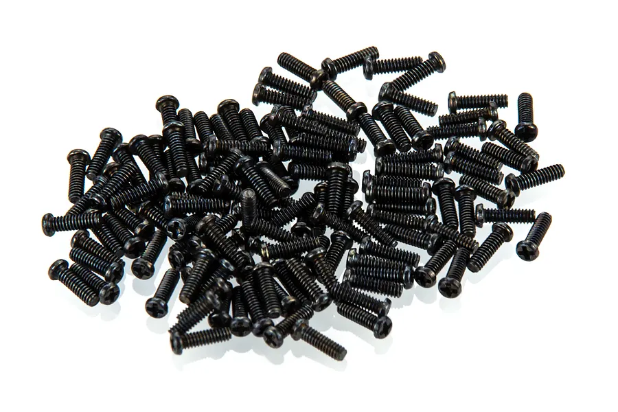 A pile of small black Phillips head screws for RC body shells on a white background.