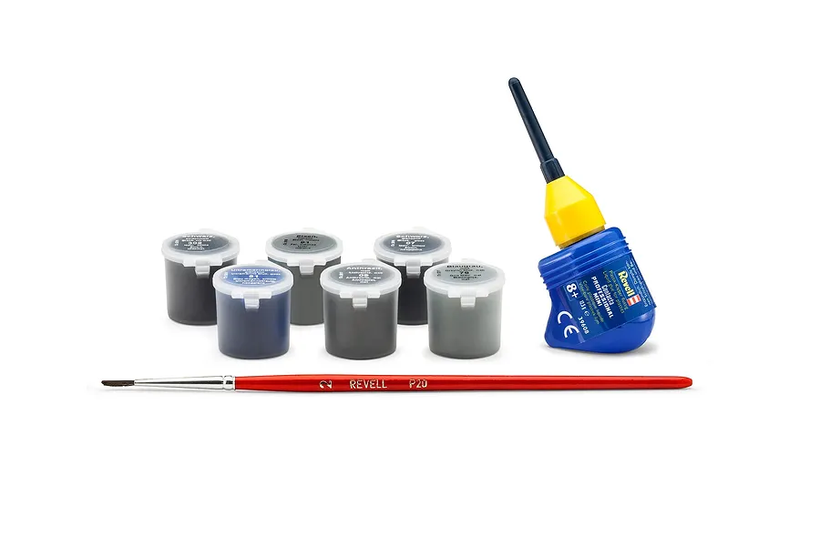 A set of Revell model building accessories including six small paint pots, a bottle of Contacta Professional glue, and a red paintbrush.