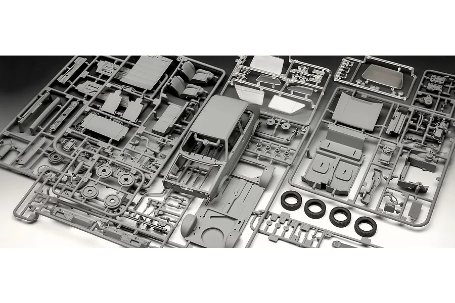 Plastic model kit sprues for a 1/24 scale 1983 VW Golf GTI, including car body, interior parts, and rubber tires.