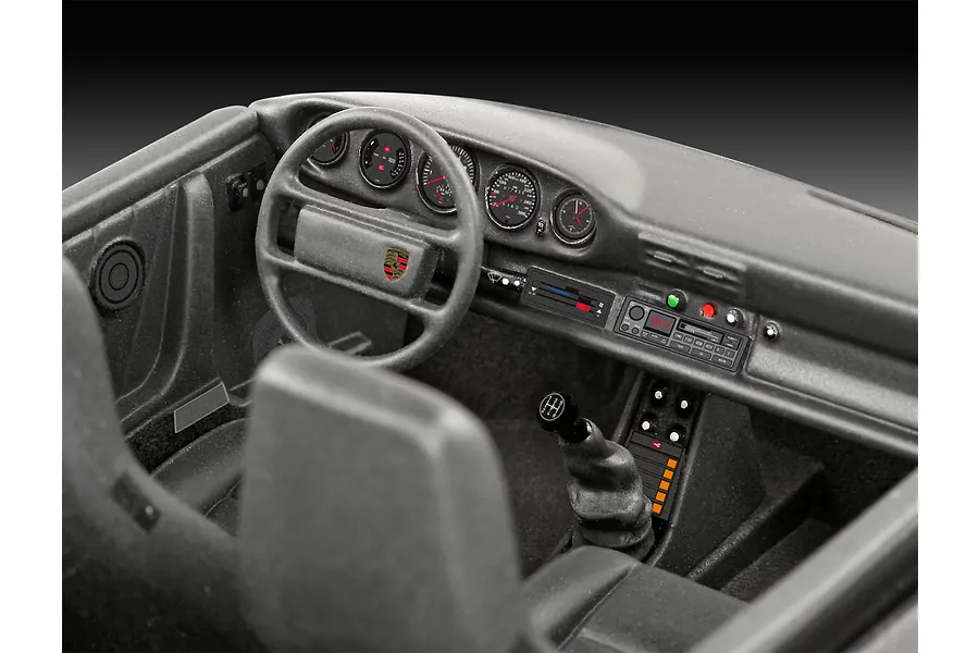 Detailed interior view of a 1/24 scale model Porsche 911 Turbo, showing the dashboard, steering wheel, and gear shifter.
