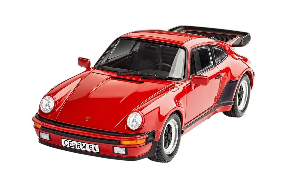 A high-angle studio shot of a red 1975 Porsche 911 Turbo plastic model car with a black rear spoiler and license plate reading CE RM 64.