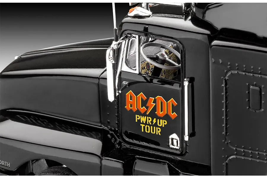 Close-up of the driver side door of a black Revell AC/DC Power Up Tour model truck, showing the logo and interior dashboard.