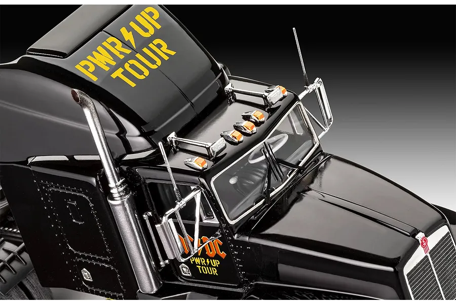Close-up of the cab of a black Revell AC/DC Power Up Tour model truck with yellow branding and chrome details.