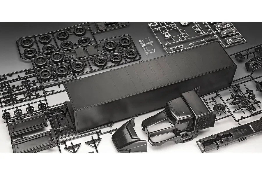 Unassembled plastic model kit parts for a semi-truck, including a large black trailer, truck cab, wheels, and chrome-plated components on sprues.