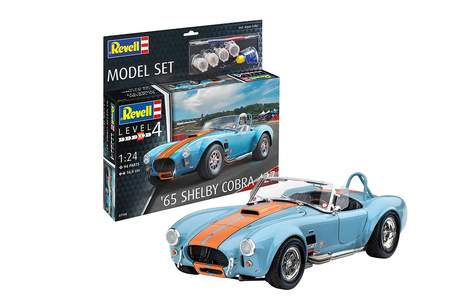 A Revell 1/24 scale '65 Shelby Cobra 427 plastic model kit box displayed alongside a fully assembled and painted light blue and orange model car.