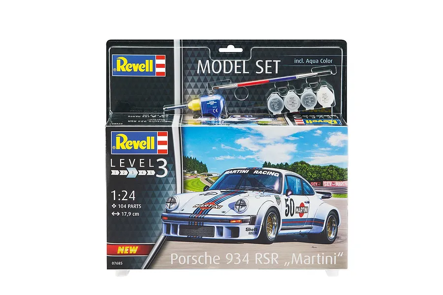 Revell 1/24 scale Porsche 934 RSR Martini model kit box including paint, glue, and a brush, displayed against a white background.