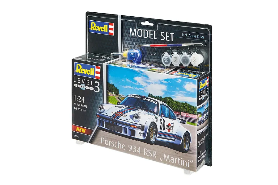 Revell 1/24 scale Porsche 934 RSR Martini model kit in blister packaging with included paints, glue, and brush.