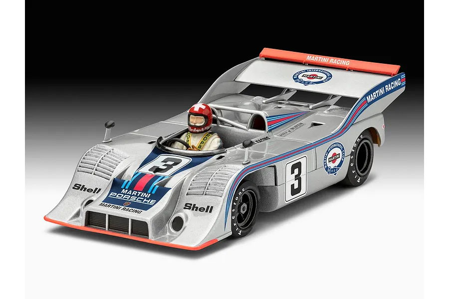 A studio shot of a completed Revell 1/32 scale Porsche 917/10 Martini racing model car with a driver figure, featuring silver paint and Martini racing decals.