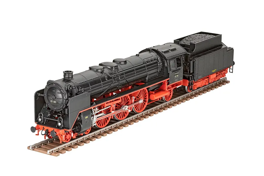 A 1/87 scale model of a black and red BR02 express steam locomotive with tender, displayed on a short section of brown model railway track.