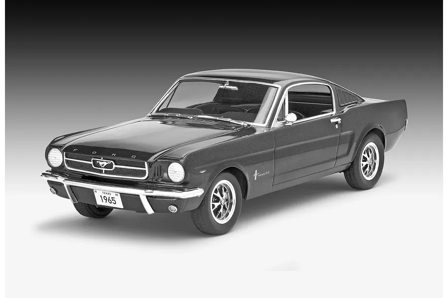 A studio shot of a completed 1/24 scale Revell 1965 Ford Mustang 2+2 Fastback model car, painted in a dark metallic grey finish.