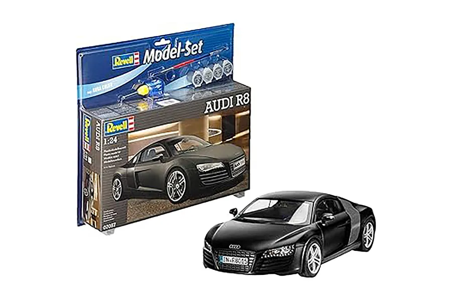 Revell 1/24 scale Audi R8 plastic model car kit in its original packaging with a finished black model car displayed in front.