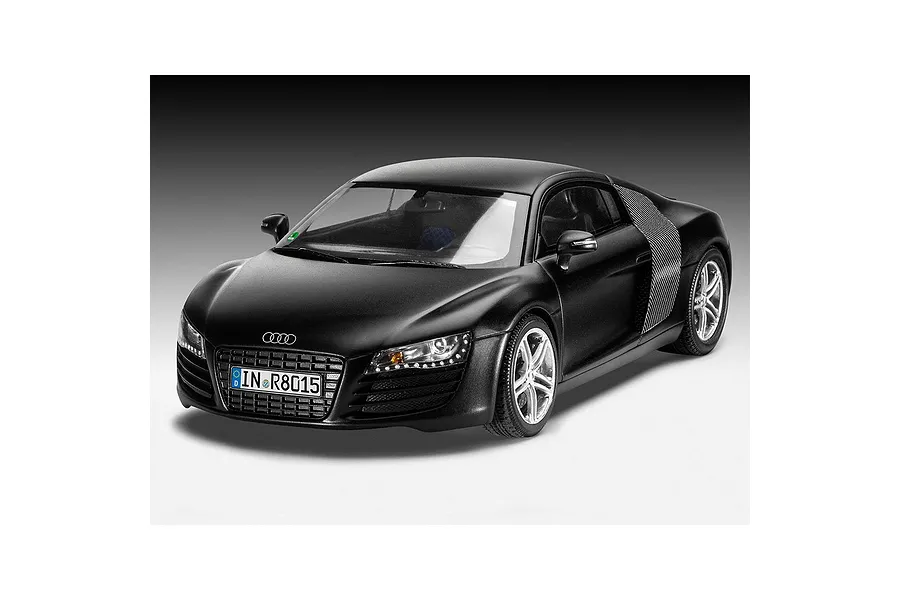 A studio shot of a 1/24 scale black Audi R8 plastic model car, showing the front three-quarter view against a gradient grey background.