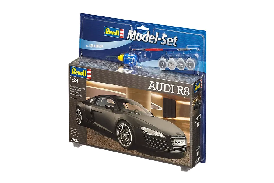 Revell 1/24 scale Audi R8 plastic model starter kit in blister packaging, including paint pots, glue, and a paintbrush.