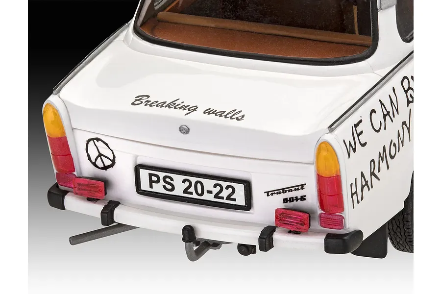 Rear view of a white 1/24 scale Trabant 601S model car featuring custom decals like 'Breaking walls' and a peace symbol.