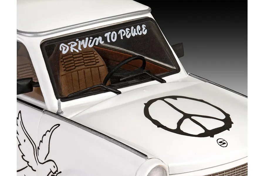 Close-up of a white Trabant 601S model car featuring a peace sign decal on the hood and DRIVIN TO PEACE text on the windshield.