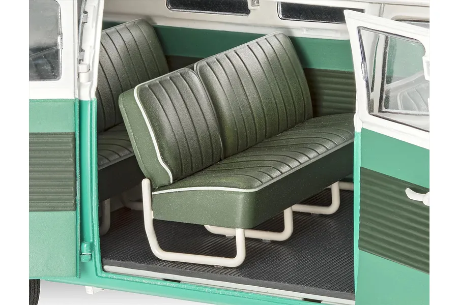 Interior view of a 1/24 scale Revell VW T1 Bus model showing green bench seats with white piping and white metal-look frames.