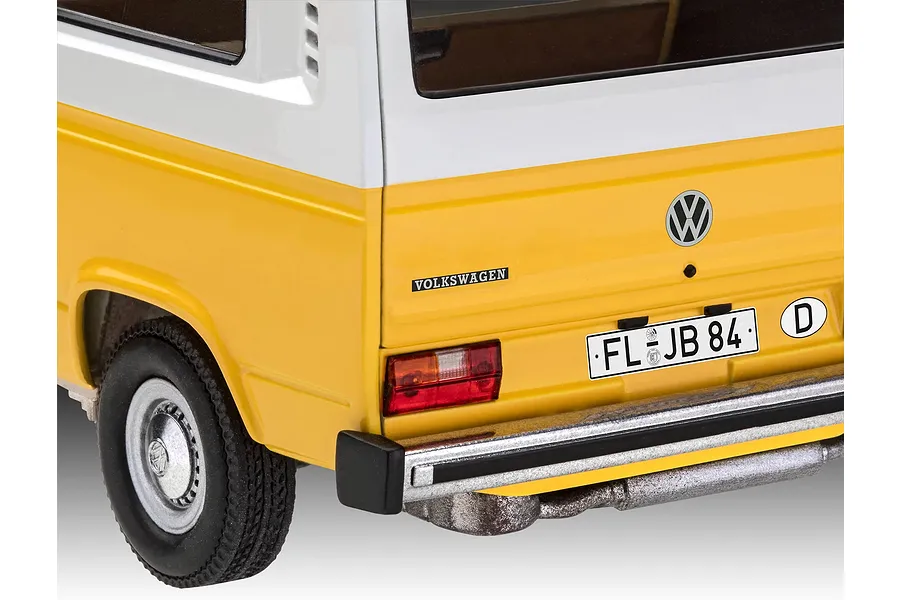 Close-up of the rear corner of a yellow and white Revell 1/24 scale VW T3 model bus showing the taillight, bumper, and license plate.