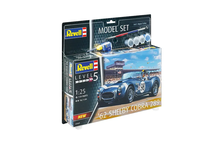 Revell 1/25 scale '62 Shelby Cobra 289 model kit in blister packaging, including paint pots, glue, and a paintbrush.